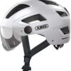 B276 ABUS Hyban 2.0 ACE kask miejski – wytrzymały kask rowerowy z wizjerem, światłem i twardą obudową ABS do codziennego użytku – dla kobiet i mężczyzn Biała (polar white) Medium